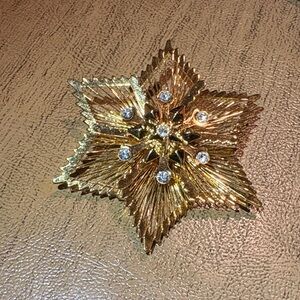 Vintage Monet Gold Starburst Floral Brooch with Clear Rhinestones
